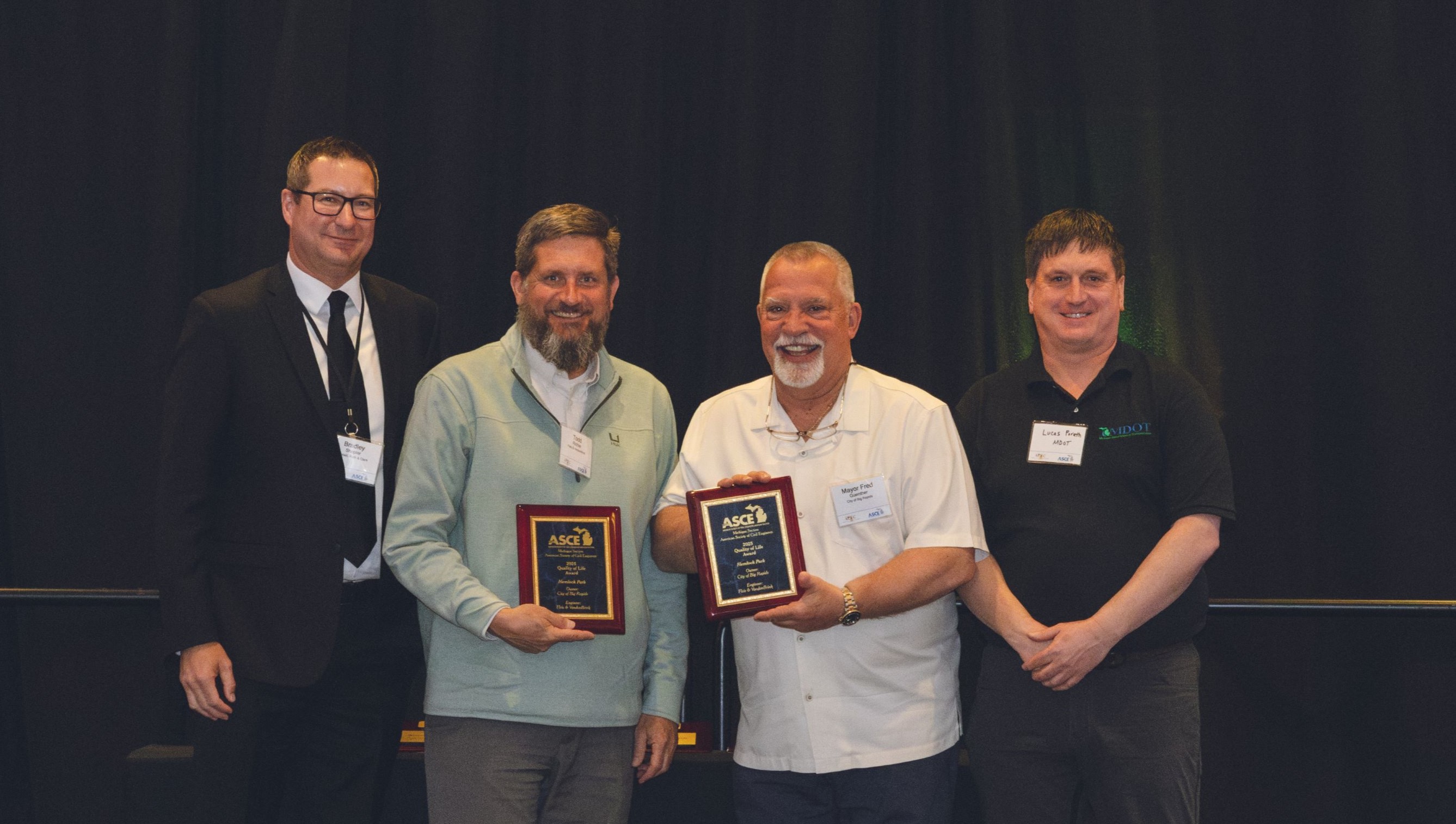 Individuals accepting award on stage