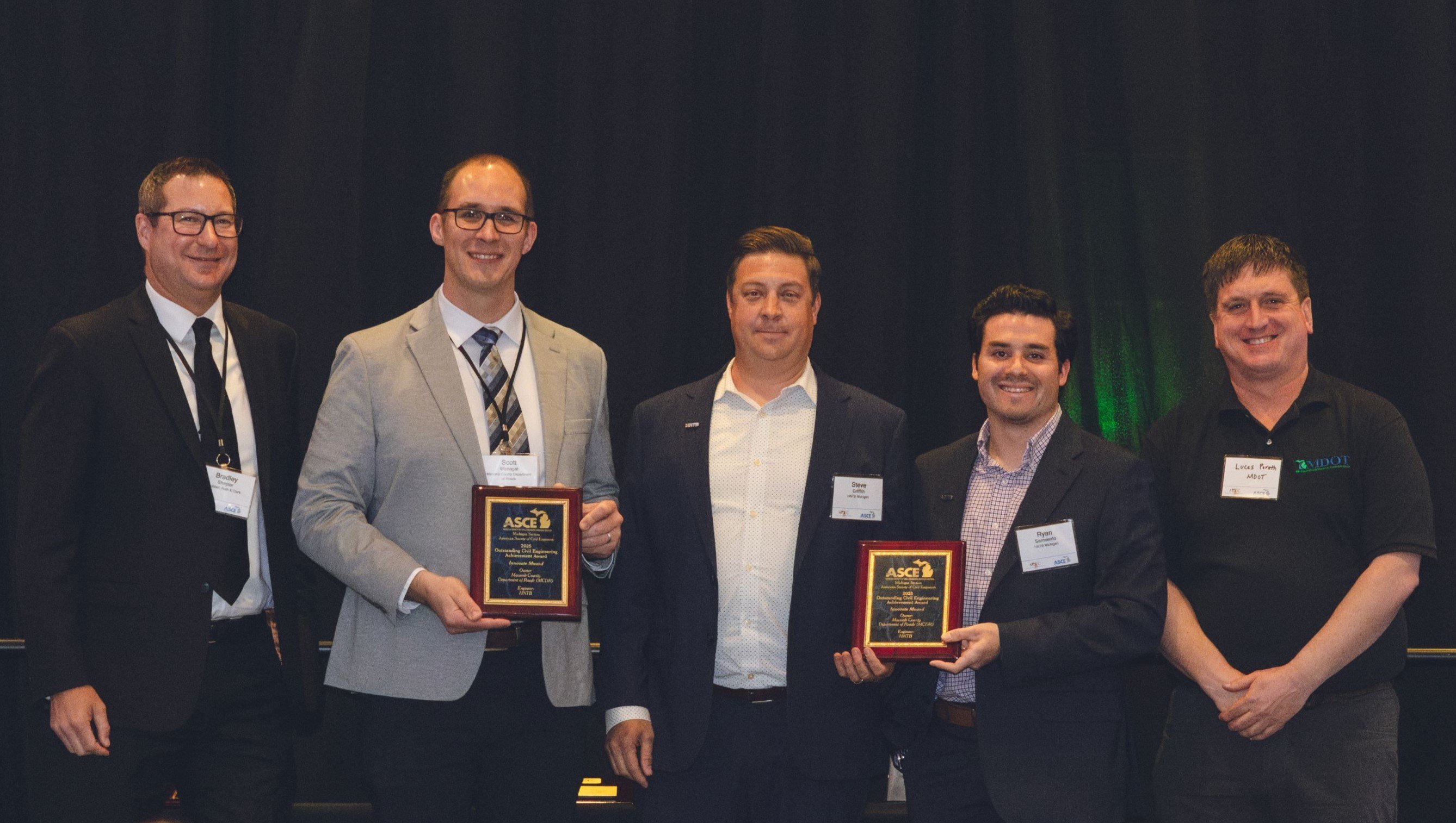 Individuals accepting award on stage